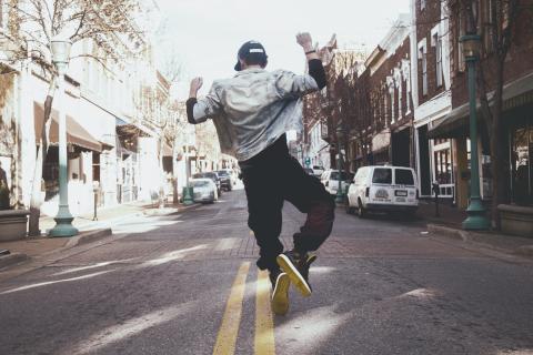 Happy person dancing in a street